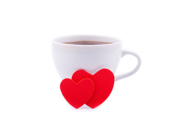 Cup of coffee and two red hearts on a white background.