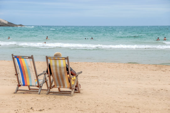 Man Sitting on Lounge Chair at the Beach in Brazil