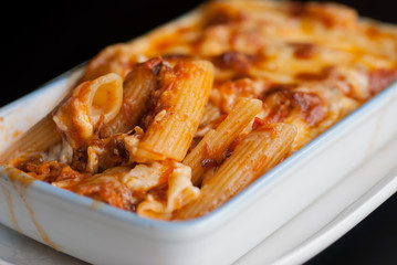 Baked penne pasta with tomato sauce and cheese