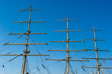 Mast of a ship on a background of blue sky.