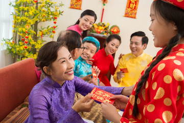 Giving a red envelope for Tet