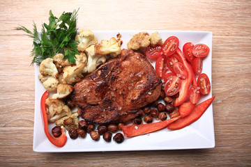 grilled meat cooked with nuts and vegetables serving