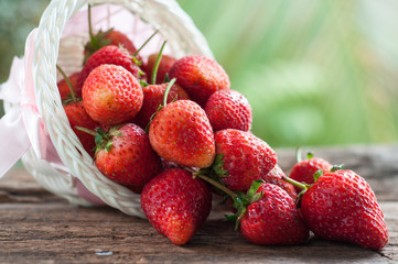 Red strawberry in basket with nature background