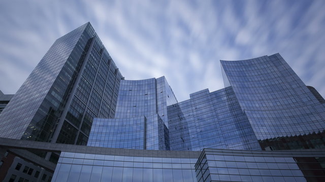 4K Time lapse glass skyscrapers zoom out