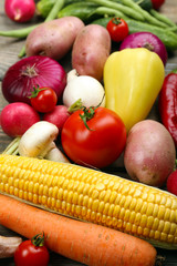 Fresh organic vegetables on wooden background