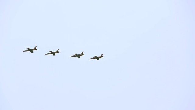 Group of four educational training aircrafts L39 flying in the