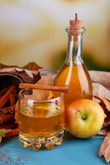 Composition of apple cider with cinnamon sticks, fresh apples