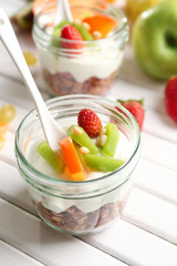 Healthy dessert with muesli and fruits on table