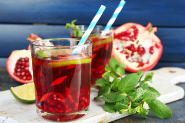 Pomegranate drink in glasses with slices of lime and mint