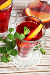 Pomegranate drink in glasses with mint and slices of orange