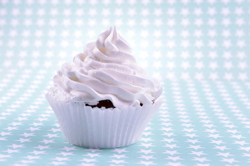 Delicious cupcake on light background