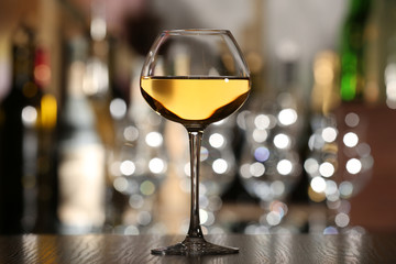 Glass of wine with bar on background