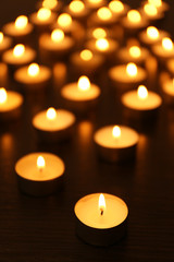 Burning candles on dark background