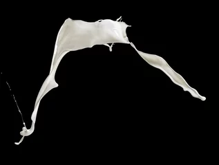 Fotobehang Milkshake flying splashing milk isolated on black background