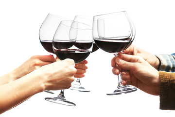 Clinking glasses of red wine in hands isolated on white