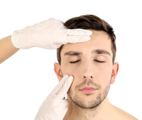 Obraz premium Doctor examines young man isolated on white