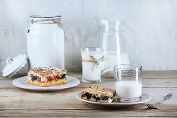 Homemade pies with jam and glass of milk