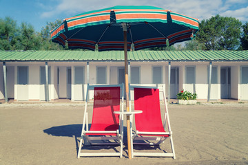 vintage beach chair, ubrella and hut.