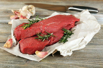 Raw beef steak with rosemary and garlic