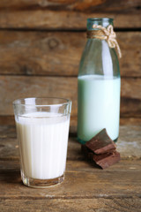 Glass and bottle of milk with chocolate chunks