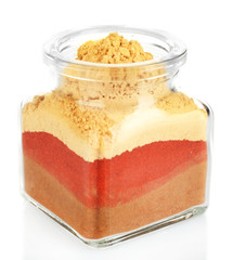 Different kinds of spices in glass bottle isolated on white