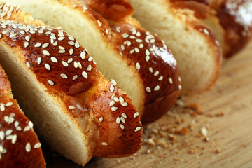 Sliced fresh bun on wooden background