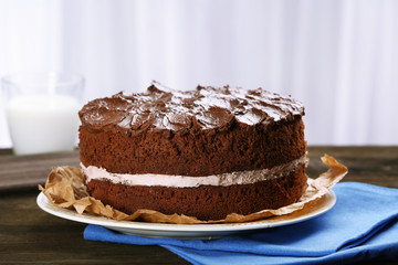 Delicious chocolate cake on table on light background