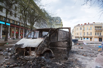 Burned car in the center of city after unrest - 78092984
