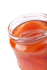 Homemade jar of apricot jam isolated on white background