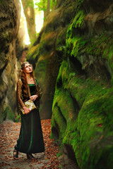 sexy girl elf in the mountains with a book