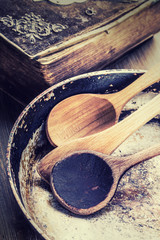 Wooden kitchen utensils on the table. Recipe book wooden spoon o