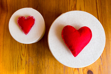 textile red hearts handmade on gift boxes on wooden background