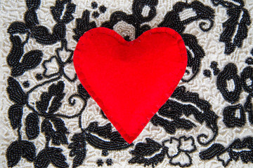 textile red heart on bead background handmade