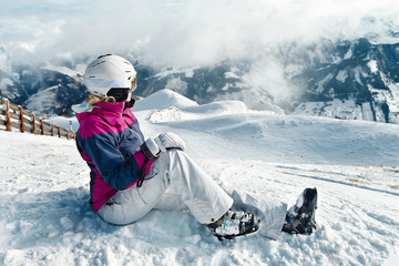 Fototapeta na wymiar Young female skier admiring the stunning view