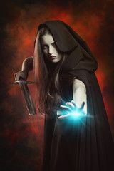 Beautiful sorceress in fighting position with sword