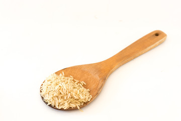 Brown Rice on Wood Ladle .