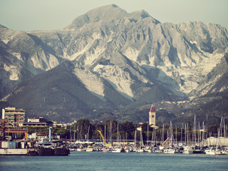Carrara marble quarries seen from offshore - Italy. Retro look.