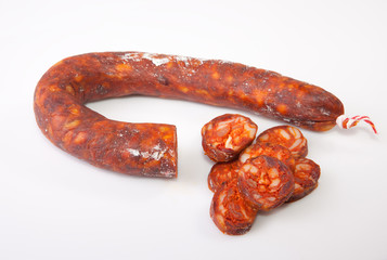 Fototapeta premium Red iberian chorizo with some cut pieces