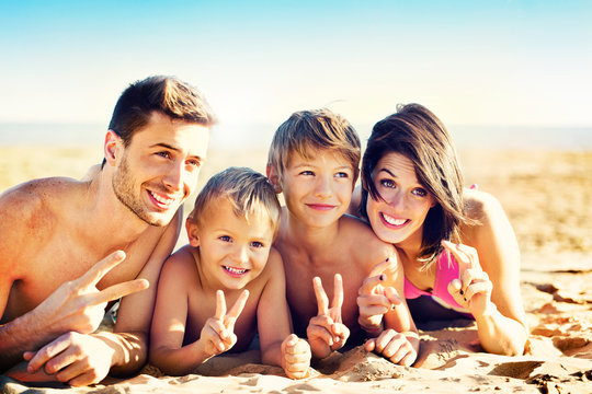 happy family posing for a souvenir photo on the beach