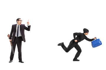 Businessman with a rifle chasing a thief