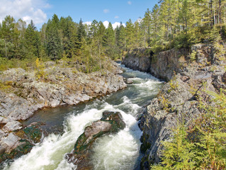 Rapid mountain river in the rocky shores