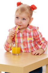 Beautiful elegant girl drinking juice from a glass.