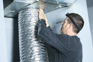 A ventilation cleaner check for dust on it.