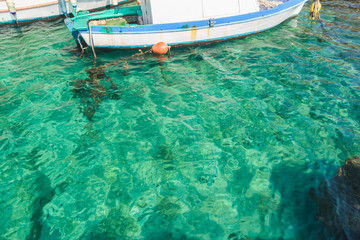 Sea boat in clear turquoise water on Greek island Kalymnos