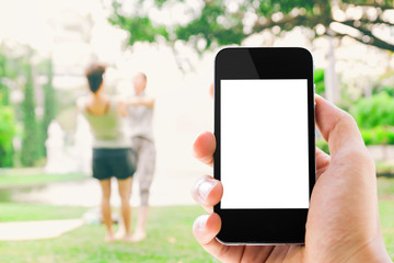 hand holding smart phone outdoor scene