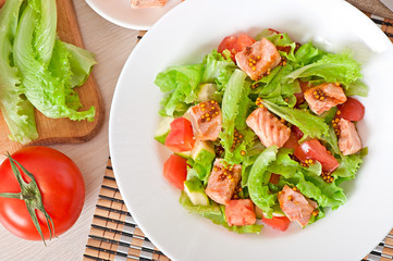 Mixed salad of fresh vegetables with pieces of salmon