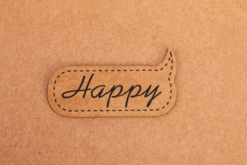 happy word tag on brown paper background