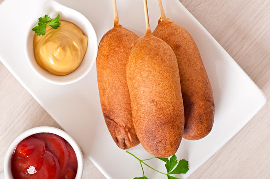 Homemade corn dogs with sauces