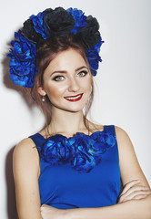 Beautiful young girl with blue flowers