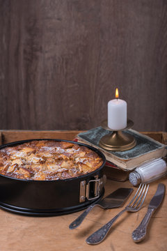 Apple pie with candle and old books